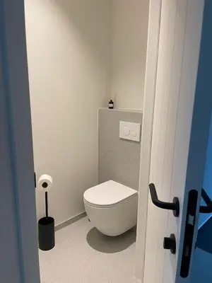 a bathroom with a white toilet in a room at De Kempische Hoef in Westerlo