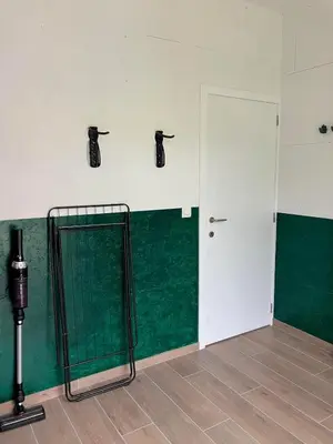 a room with a green and white wall and a door at Tampico, Holiday Home at river Schelde in Hamme