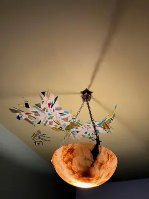 aendant light hanging from a ceiling with a rock at Tampico, Holiday Home at river Schelde in Hamme
