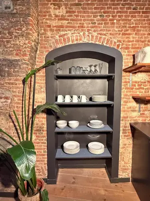 a shelf with plates on it in a brick wall at NEW Central old town - Exclusive Residences in Antwerp