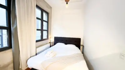 a bed in a room with two towels on it at NEW Central old town - Exclusive Residences in Antwerp