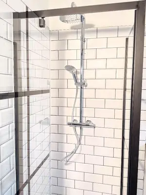 a bathroom with a shower with white subway tiles at NEW Central old town - Exclusive Residences in Antwerp