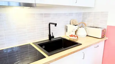 a kitchen counter with a sink and a microwave at NEW Central old town - Exclusive Residences in Antwerp