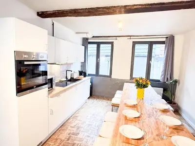 a kitchen with a long table with plates on it at NEW Central old town - Exclusive Residences in Antwerp