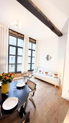 a living room with a table and a couch at NEW Central old town - Exclusive Residences in Antwerp
