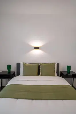 a bedroom with a large bed with two night stands at Malbeek 7 in Brussels