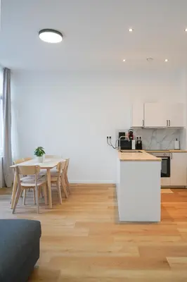 a kitchen and dining room with a table and chairs at Appartment Jacobs 6 in Brussels