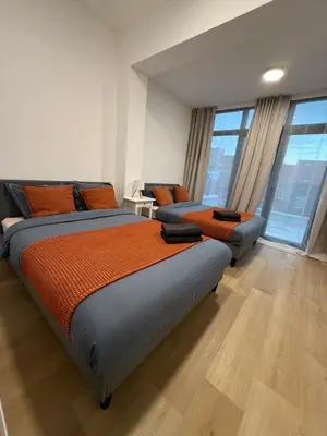 a bedroom with two beds with orange pillows at Appartment Jacobs 6 in Brussels