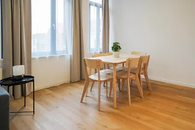 a dining room table and chairs in a room at Appartment Jacobs 6 in Brussels