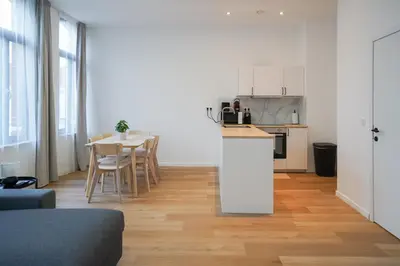 a kitchen and living room with a table and chairs at Appartment Jacobs 6 in Brussels