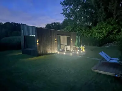 a small shed with a table and chairs in a yard at Black Pearl in Hamme