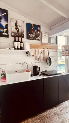 a kitchen with a sink and a counter with utensils at Chambre d Amis in Lokeren