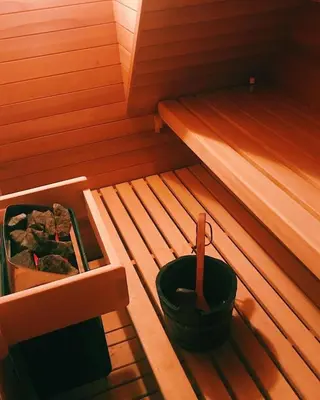 an inside of a sauna with a bucket in it at Chambre d Amis in Lokeren