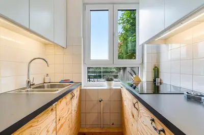 a kitchen with a sink and a window at Fuths Penthouse 55 in Antwerp