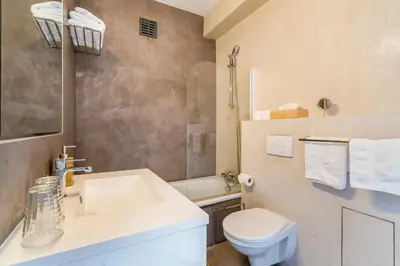 a bathroom with a white sink and a toilet at Fuths Penthouse 55 in Antwerp