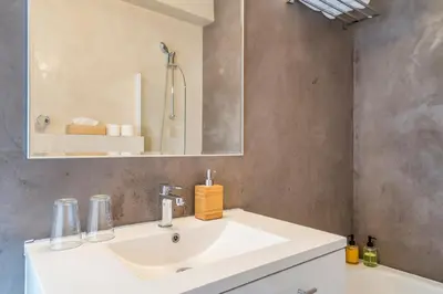 a bathroom with a white sink and a mirror at Fuths Penthouse 55 in Antwerp