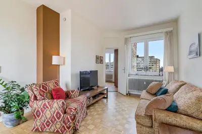a living room with two couches and a tv at Fuths Penthouse 55 in Antwerp