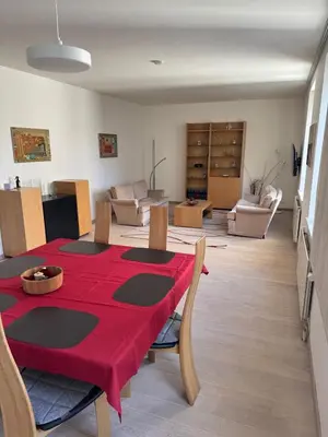 a living room with a table with a red table cloth at Oase in the City in Brussels