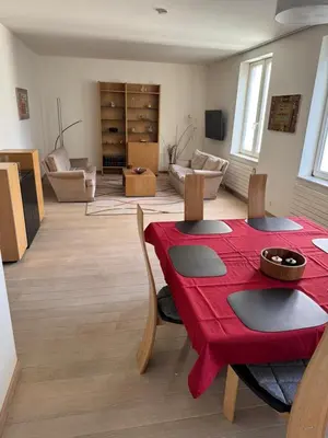 a living room with a red table and chairs at Oase in the City in Brussels