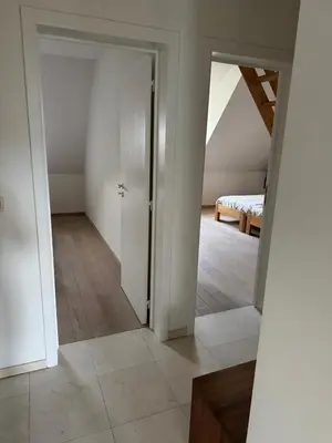 an empty room with a door leading to a bedroom at Oase in the City in Brussels