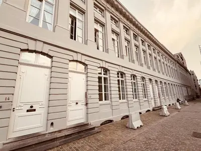 a row of white doors on a building at Oase in the City in Brussels
