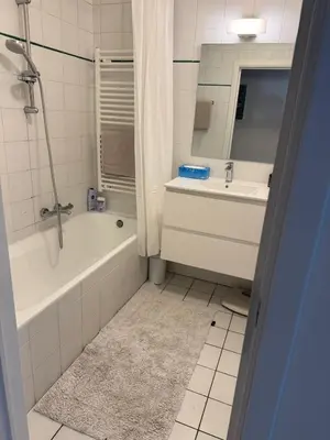 a bathroom with a bath tub and a sink at Oase in the City in Brussels