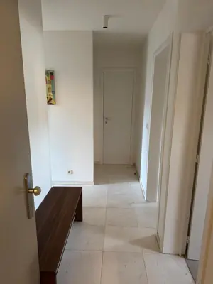 an empty hallway with a wooden bench in a room at Oase in the City in Brussels