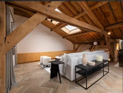 a living room with a white couch and a table at Luxury Designer Penthouse with Roof Terrace in Antwerp