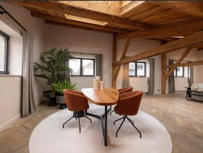 a dining room with a table and chairs at Luxury Designer Penthouse with Roof Terrace in Antwerp