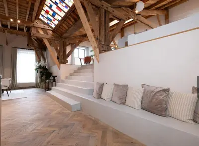 a living room with a long bench with pillows at Luxury Designer Penthouse with Roof Terrace in Antwerp