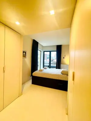 a small room with a bed and a window at Elegant Central Apartment Quiet and Bright in Brussels