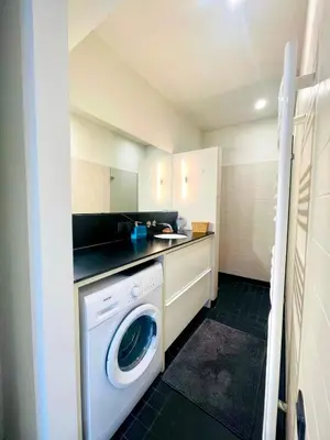 a small kitchen with a washing machine in it at Elegant Central Apartment Quiet and Bright in Brussels