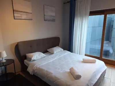 a bed with two towels on it in a bedroom at Résidence des sables in Brussels