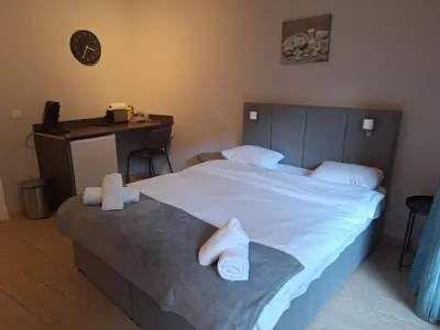 a bedroom with a large bed with towels on it at Résidence des sables in Brussels