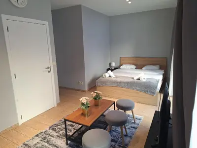 a bedroom with a bed and a table with chairs at Résidence des sables in Brussels