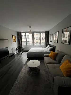 a living room with a couch and a bed at Loft Tarantino au cœur de Bruxelles in Brussels