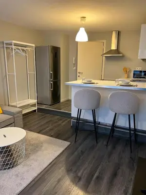 a kitchen with two stools and a counter in a room at Loft Tarantino au cœur de Bruxelles in Brussels