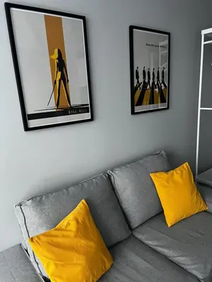 a living room with a gray couch with yellow pillows at Loft Tarantino au cœur de Bruxelles in Brussels