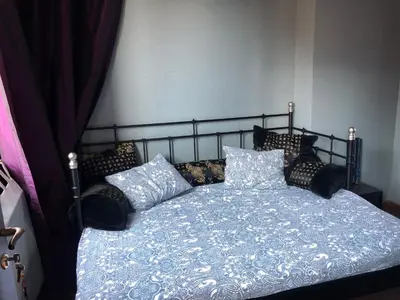 a bedroom with a bed with a blue comforter and pillows at House Le Prince D'Anvers in Antwerp