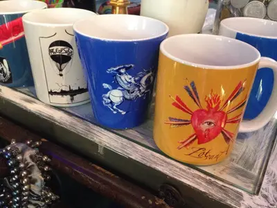 a group of coffee cups sitting on a shelf at House Le Prince D'Anvers in Antwerp