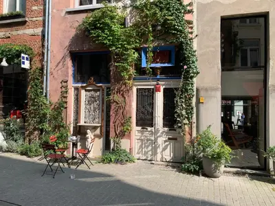 a building with a table and chairs in front of it at House Le Prince D'Anvers in Antwerp