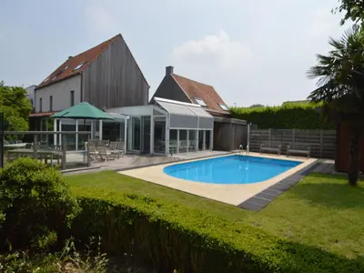 a swimming pool in a yard next to a house at Splendid villa in Flemish Ardennes with pool in Wolvenhoek