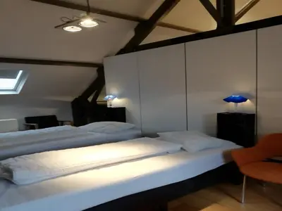 a bedroom with two beds and a blue lamp at Splendid villa in Flemish Ardennes with pool in Wolvenhoek