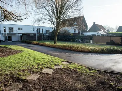 a driveway with a tree and a house at Holiday home in Zottegem in Zottegem
