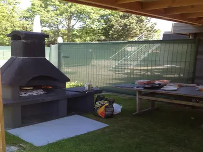 a outdoor grill with a picnic table and a table with food at Holiday home in Zottegem in Zottegem
