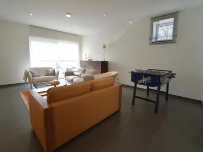 a living room with a couch and a table with a game at Holiday home in Zottegem in Zottegem