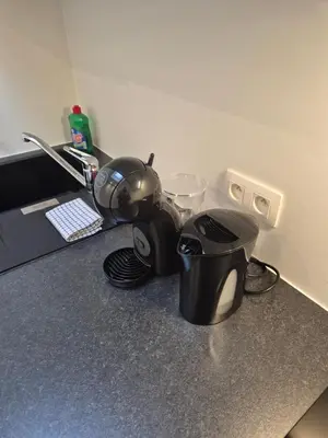 a kitchen counter with a tea pot and a toaster at Huis ALNA 10 in Mechelen