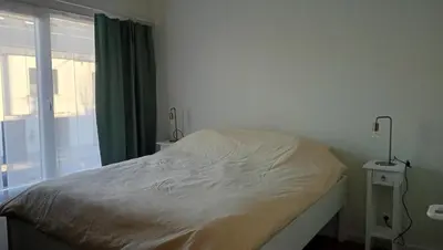 a bed in a room with a window and a bedskirtspectspectspectspects at Lieria in Lier