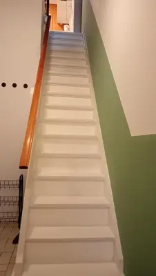 a stairway with white stairs in a room at Lieria in Lier