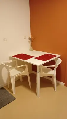 a white table with two chairs and a table with a red table cloth at Lieria in Lier